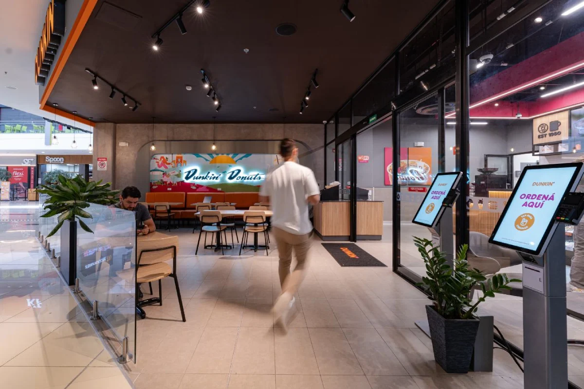 Dunkin Donuts - Customer flow entry view showing digital ordering kiosks and clear wayfinding - Contract Workplaces.webp